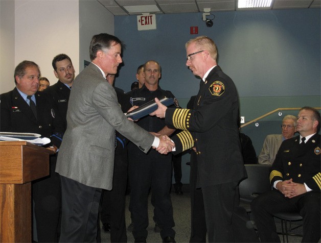 Chief Deputy U.S. Marshal David Miller presents certificates of appreciation to individuals and emergency responders who helped save the life of Mercer Island resident Jack Williams.