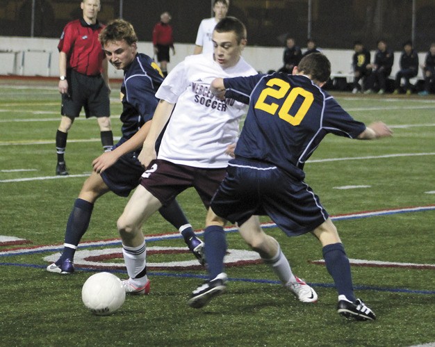 Mercer Island's Logan Barton-Rowledge tries to get through several Bellevue players during the Islanders home win over the Wolverines on Tuesday