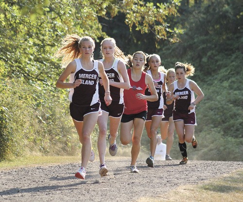 Members of the Mercer Island and Sammamish girls cross country team run during the first lap of the race on Wednesday