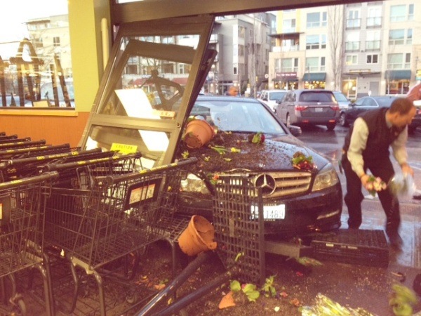 A woman driving a black Mercedes Benz crashed into the front of the North-end QFC on Tuesday