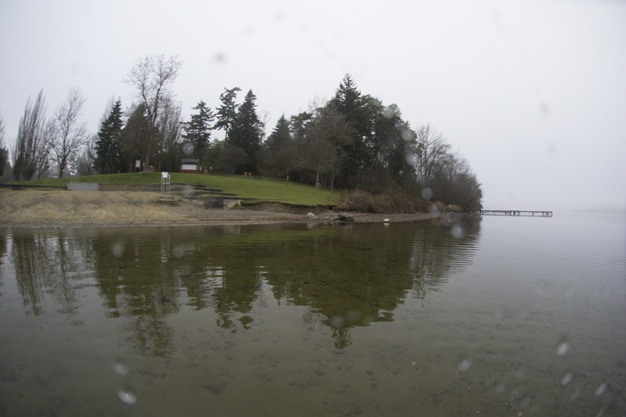Fog hovers over Lake Washington and Mercer Island at Luther Burbank Park on Sunday