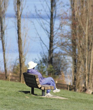 A woman enjoys the sunshine while sitting at Luther Burbank Park in early March.