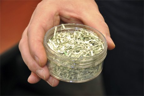 Police Detective Pete Erickson holds up a small sampling of the shredded currency found on Oct. 29.