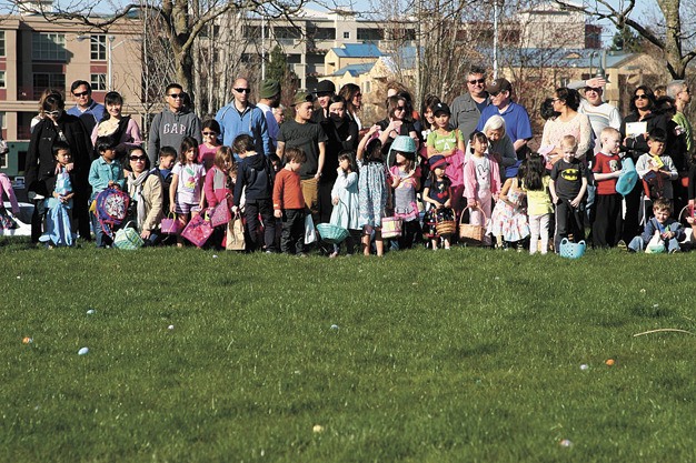 Families line up before the Lil’ Ones Egg Hunt on Saturday