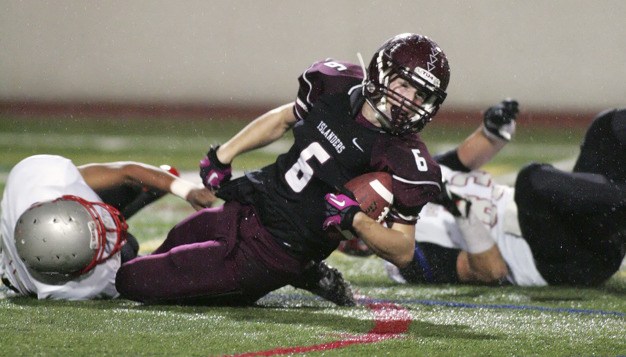 Mercer Island running back Risley Lesko is tackled for a loss in the backfield by two Mt. Si defenders in the Islanders' 38-7 homecoming loss on Friday night.