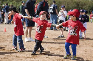 Little Leaguers enjoy the infield dirt while watching and participating in the Opening Day ceremonies at the South Mercer Playfields on Mercer Island