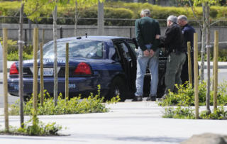 Mercer Island police officers arrest a man at the Mercer Island Park and Ride on April 30.