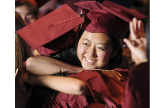 Hannah Choi smiles as she wraps her arms around a friend.