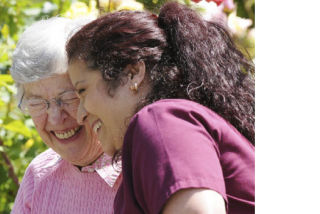 Covenant Shores resident Joyce Ostergren shares a laugh with her student