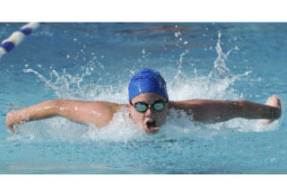 Mercer Island Country Club swimmer Caitlin Aylward takes the third leg of the girls 15-and-over 200-meter medley relay on Thursday at the Mercerwood Shore Club.