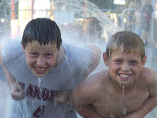 Islanders Josh Stenberg and Nate Schuler take time to cool off at the River Front fountain during the 2008 Spokane Hoopfest. Stenberg’s Cloud Nine team won its division by going 5-0