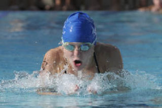 Shore Club swimmer Julia Davis helps the 13- and 14-year-old girls 200-meter medley relay team to victory against Newport Hills on Thursday.