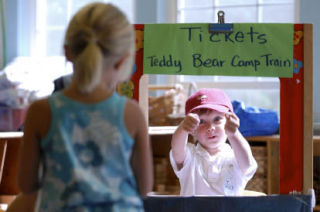 Jack Beebe encourages a fellow day-camper to ride the train at Teddy Bear Camp on Mercer Island.