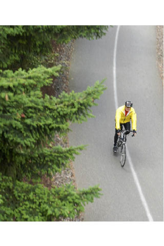 A cyclist eases his pedal during a downhill coast along a bike trail in the Park on the Lid on Thursday