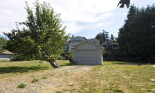 A vacant lot in the 2400 block of 60th Avenue S.E. in the East Seattle neighborhood of Mercer Island is listed for sale with an asking price of $1.95 million. It has a view of Lake Washington and the I-90 bridge. It is one of 29 pieces of vacant residential land for sale on the Island.