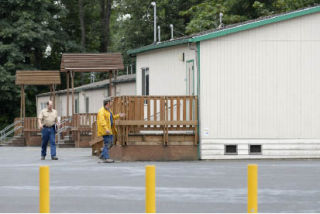 Contractors assess the proposed location to add a portable classroom at Lakeridge Elementary School on Mercer Island