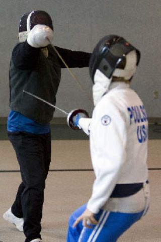 Instructor Kevin Mar and 12-year-old Lauren Poulson spar during a fencing class at the Issaquah Community Center.