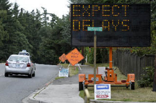 Flashing signs warn southbound drivers on Island Crest Way of construction delays along S.E. 40th Street on Mercer Island last week.