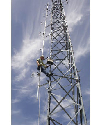 A contractor climbs the radio tower at Mercer Island High School to switch the transmission frequency. The high school radio station recently switched to the opposite end of the dial. Tune in to 88.9 FM from now on.