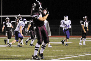 Islanders WR Treston Donovan (84) keeps his toes in bounds after a leaping catch late in the fourth quarter to help Mercer Island hang on to a 7-6 victory over Lake Washington in the season opener at Islander Stadium