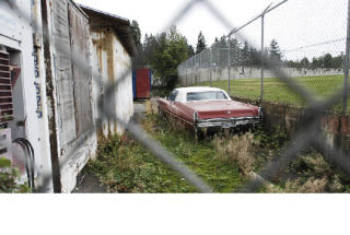 Rotting storage units and an abandoned car sit behind Youth Theatre Northwest in the North Mercer complex of the Mercer Island School District. A study for the planned 2009 facilities bond indicates that repairs to the North Mercer campus are a district priority.