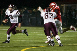 Mercer Island freshman quarterback Jeff Lindquist scrambles from the pocket during the Islanders 41-16 loss to Mount Si on Friday. Lindquist accounted for both of the Islanders’ touchdowns during the game