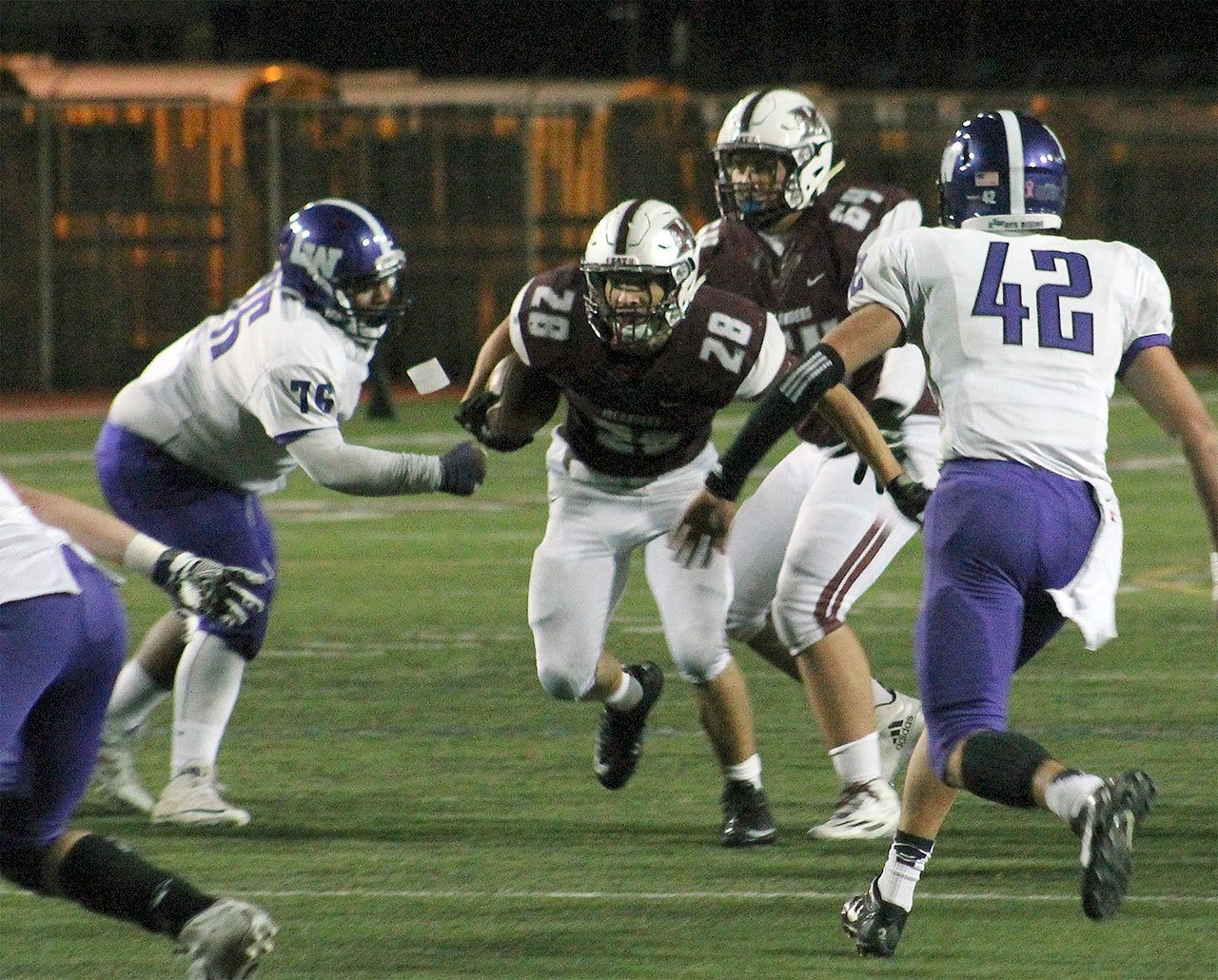 Mercer Island’s Jordano Mark (28) rushes against Lake Washington Oct. 21 at Islander Stadium (Joe Livarchik/staff photo).