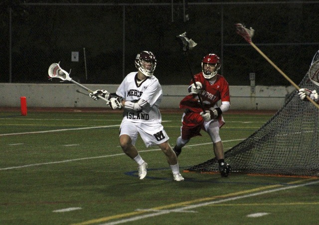 Joe Livarchik/staff photoMercer Island’s Mitchell Mandt maneuvers around Newport defender Justin Anderson Friday night at Islander Stadium. Mandt posted five goals and two assists as the Islanders shut out the Knights 18-0.