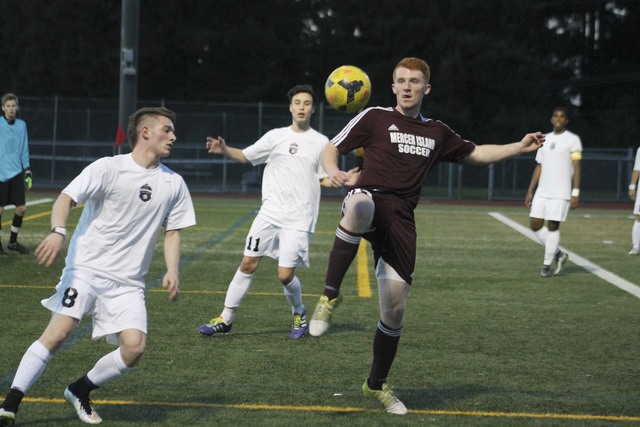 Joe Livarchik/staff photoMercer Island’s Austin Taylor fights for possession against Lake Washington’s George Lymberis (8) Friday at Lake Washington High School. The Islanders beat the Kangs 4-0.