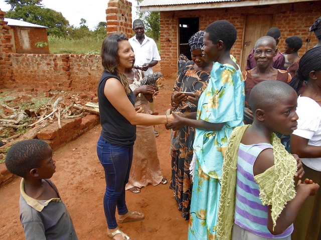Einstein Rising founder Alexis Chavez meets with the beneficiaries of a company called Tusobola
