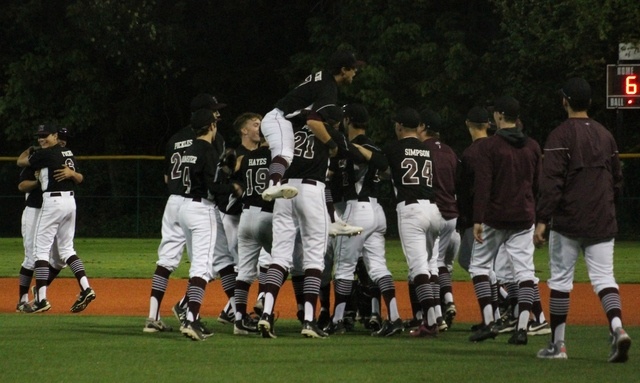 Members of the Mercer Island baseball team celebrate after clinching the 3A KingCo league title with a 6-1 victory over Juanita Friday night at Island Crest Park (Joe Livarchik/staff photo).