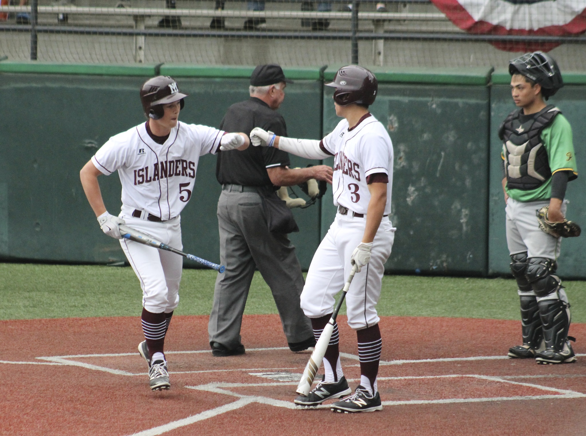Mercer Island’s Josh Stenberg (5) is greeted by Anthony Scalzo (3) after hitting a solo home run against Roosevelt Saturday at Steve Cox Memorial Park in Seattle. The Islanders beat the Rough Riders 3-1 to advance to the 3A state regionals (Joe Livarchik/staff photo).
