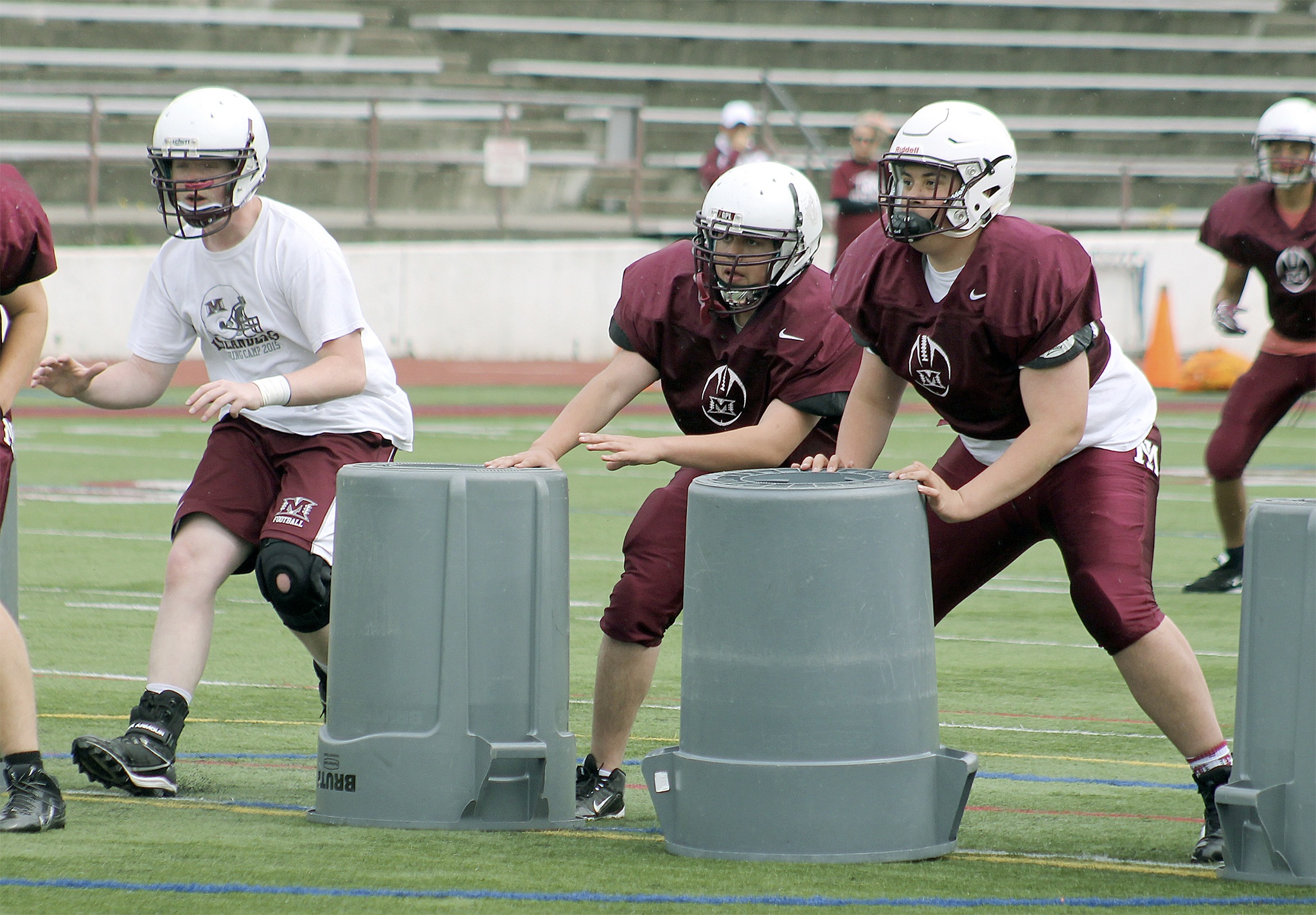 Members of the Mercer Island football team take part in defensive drills during spring football practice June 2 at Mercer Island High School (Joe Livarchik/staff photo).