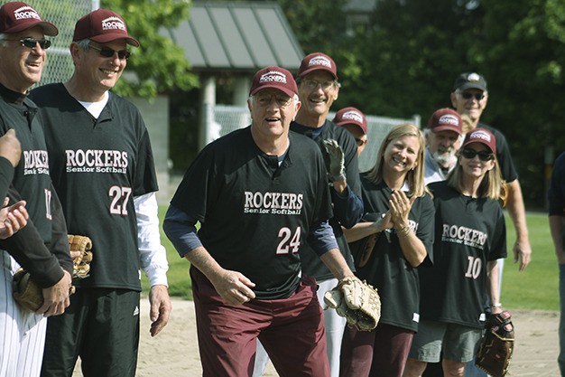 The Mercer Island Rockers surprised longtime pitcher John Weinberg (24) with the duty of throwing out the ceremonial first pitch at the team’s home opener Thursday