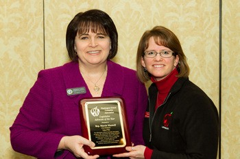 Rep. Marcie Maxwell accepts the Legislative Advocate of the Year award from Olympia High School counselor Kim Reykdal.