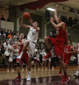 Mercer Island's Sam Nordale (11) goes up for the dunk over King's Chewy Zevenbergen Friday