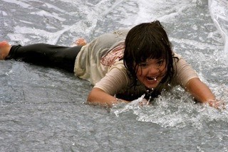Islander Riley Marceau has a blast on the water slide during Autism Day at Jubilee Farm last summer.