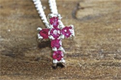Pieces like this ruby cross are a part of Lisa Novak’s Amen Jewelry line.