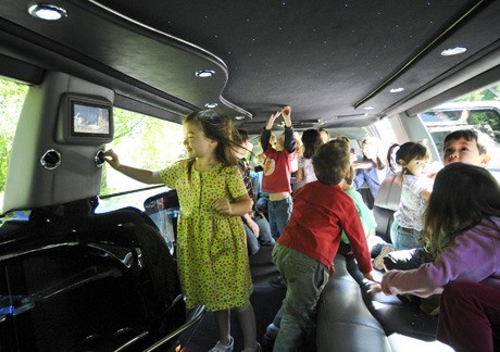 Students in the Stroum Jewish Community Center’s Early Childhood Services program fill the back of a Rare Form limousine during the school’s annual Truck Day event.