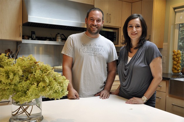 Sam Alhadeff and Renee Antezana stand together in the kitchen of their latest Mercer Island remodel project