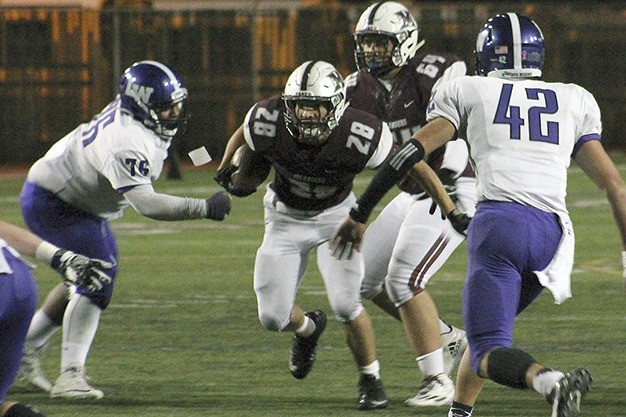 Mercer Island's Jordano Mark (28) rushes against Lake Washington Oct. 21 at Islander Stadium.