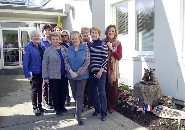 Mercer Island Sister City Association members pose with the new 'Twin Foxes' sculpture outside City Hall on Saturday.