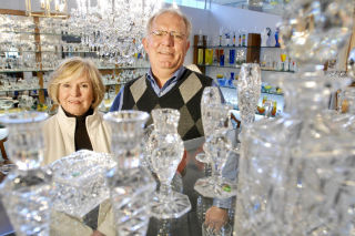 Kris and Chuck Kusak are pictured in the showroom at Kusak Cut Glass Works in the Rainier Valley last week.