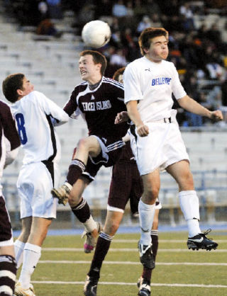 Islander Derek Johnson battles a pair of Bellevue players for control of the ball as Mercer Island pulled out a 3-2 overtime victory against the school’s biggest rival.