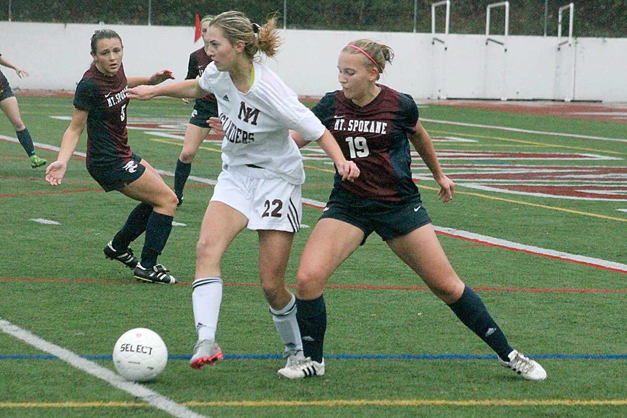 Mercer Island forward Nicole Mandt (22) fights off Mt. Spokane defender Emily Hahn during the Islanders’ winner-to-state matchup against the Wildcats Saturday at Islander Stadium. Mercer Island won 2-0. Joe Livarchik/staff photo.