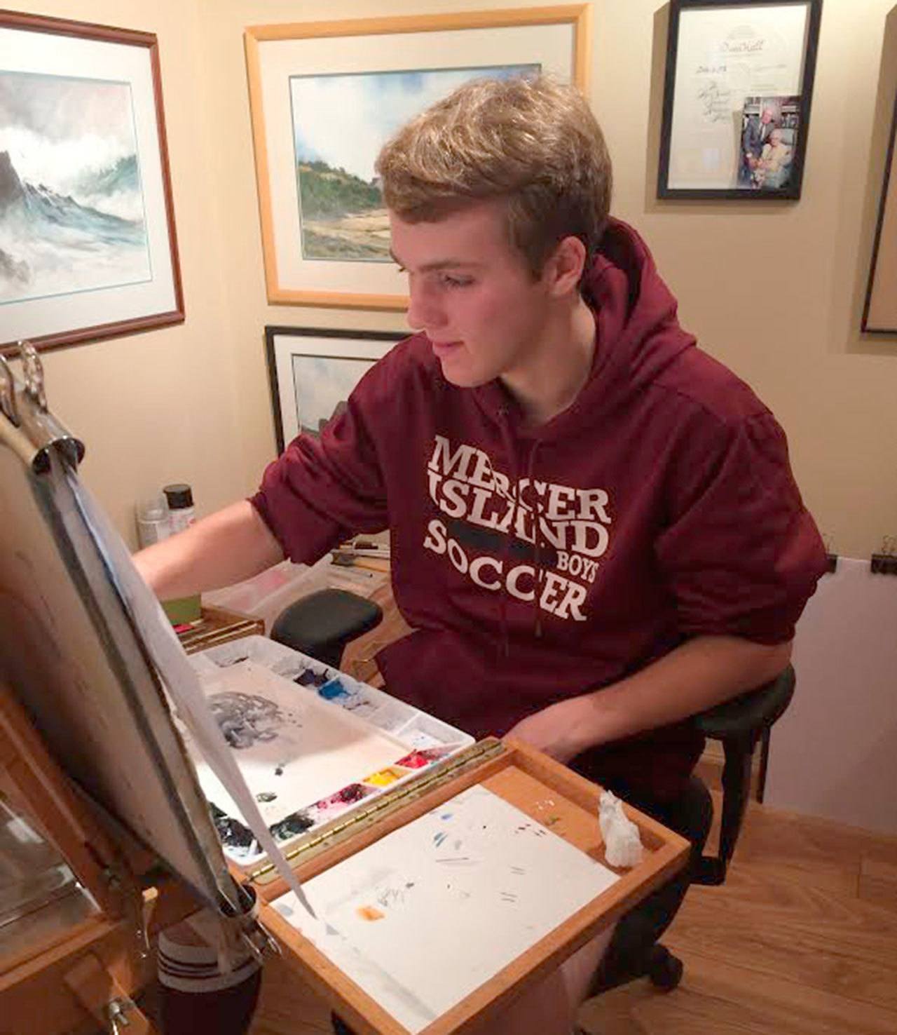 Brandon Hill works on a watercolor painting in his grandfather Owen Hall’s studio. Hill and Hall are both Mercer Island residents. Photo courtesy of Virl Hill