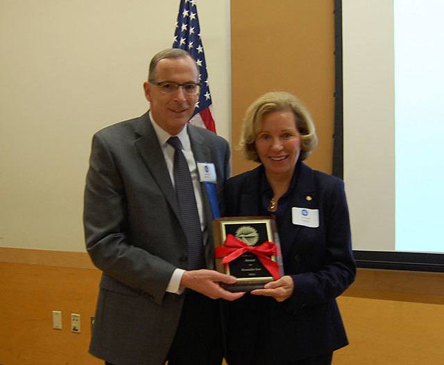 Mercer Island Chamber of Commerce President Ralph Swanson presents Roanoke owner Dorothy Reeck with the 2016 Business of the Year award at the Dec. 1 luncheon. Katie Metzger/staff photo