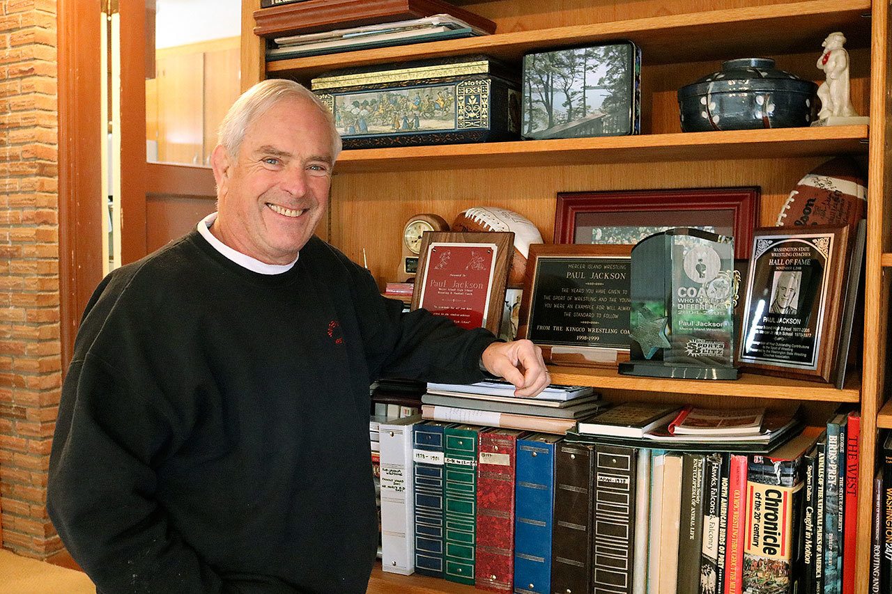 Paul Jackson with his trophy shelf at his Mercer Island home. In March, Jackson will be inducted into the National Wrestling Hall of Fame for lifetime service to the sport. Joe Livarchik/staff photo.