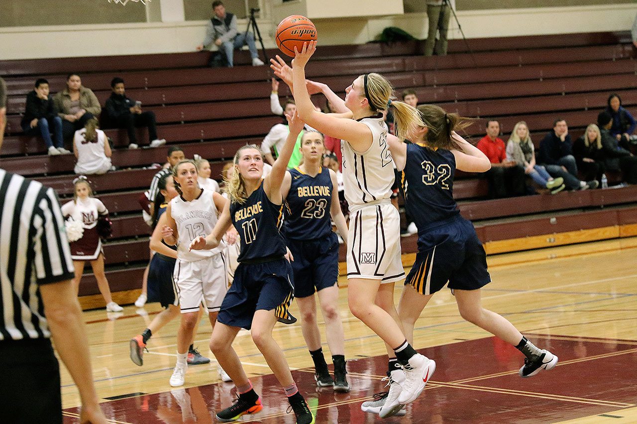 Mercer Island’s Anna Luce shoots over Bellevue’s Kathryn Roberts (11) Monday at Mercer Island High School. The Islanders beat the Wolverines 67-44. Photo courtesy of Willy Paine.