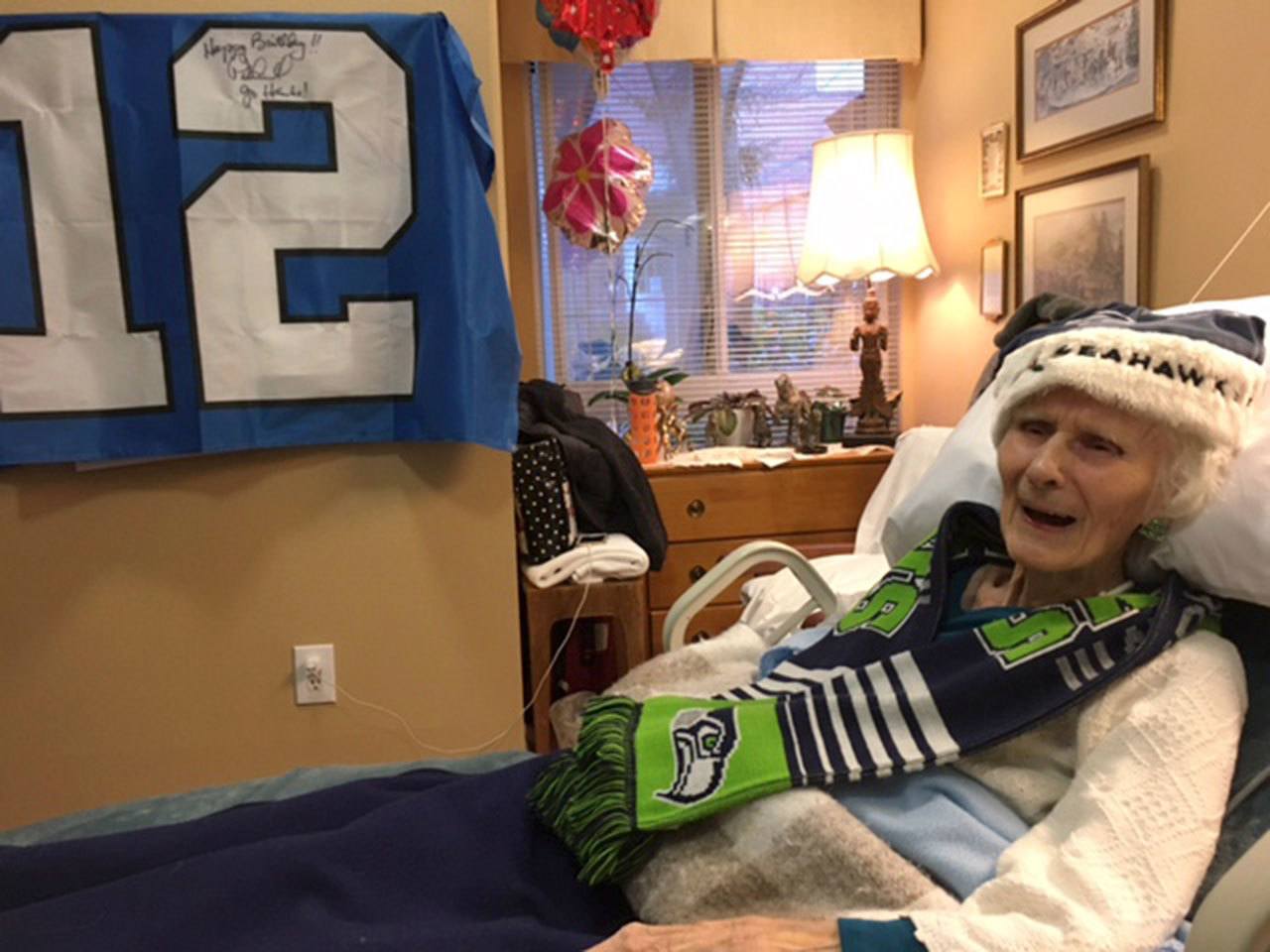 100-year-old Lois Lawson got a signed Seahawks flag for her birthday. Photos courtesy of Greg Asimakoupoulos